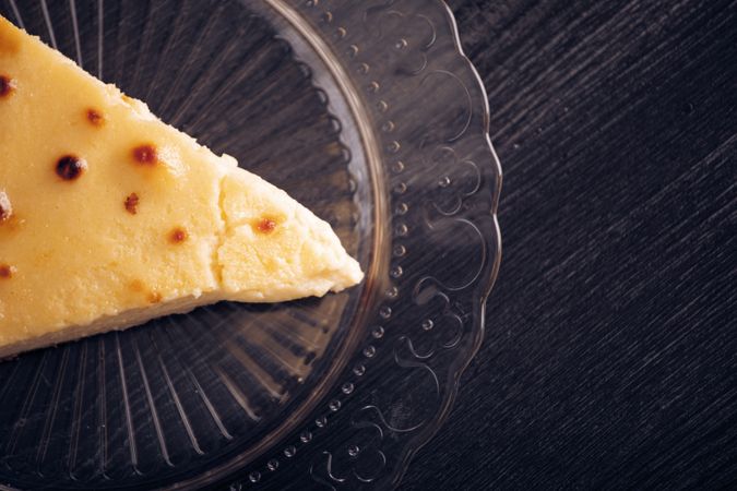 Baked cheesecake with red jam in glass plate