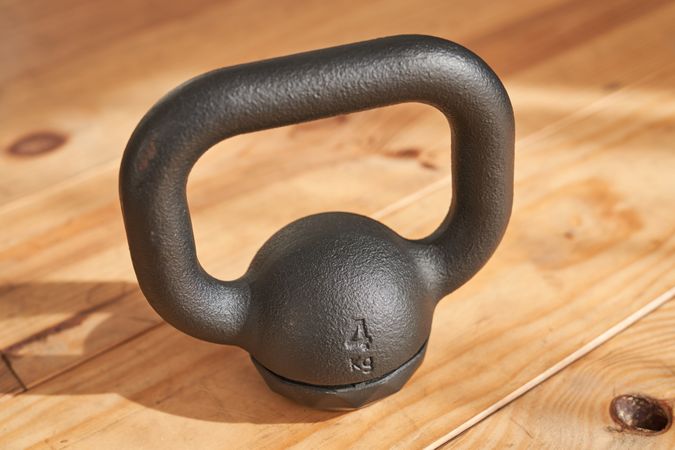 Metal kettlebell placed on parquet