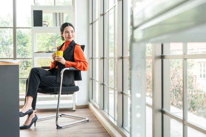 Smiling and cheerful woman in a bright office