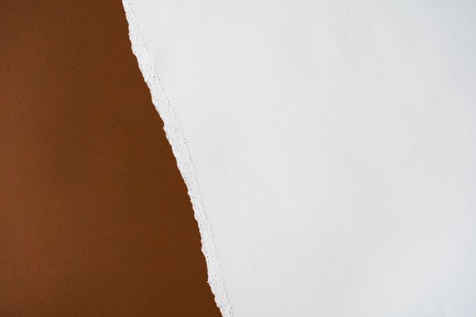 Earthy brown and light torn paper background