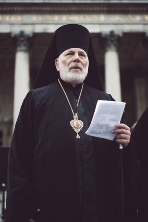 London, England, United Kingdom - March 5 2022: Orthodox priest reading from paper outside