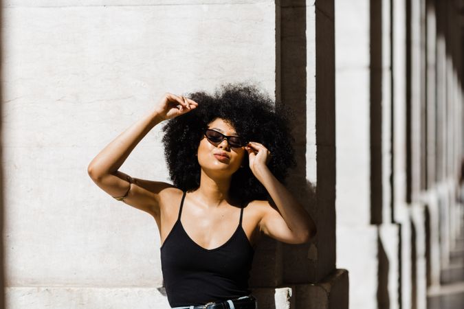 Cheerful Black female in dark sunglasses