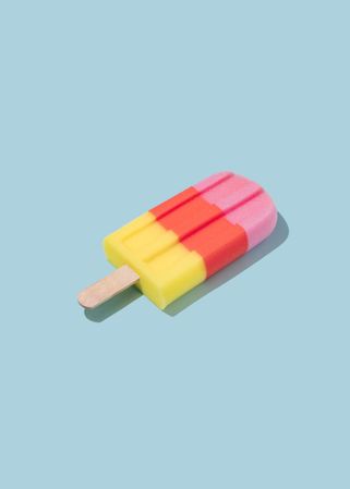 Colorful ice cream popsicle on pastel blue background