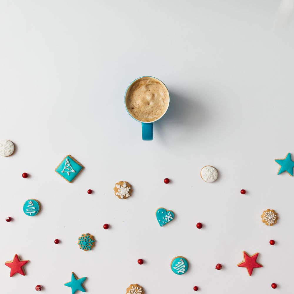 Christmas cookies and red berries with coffee cup