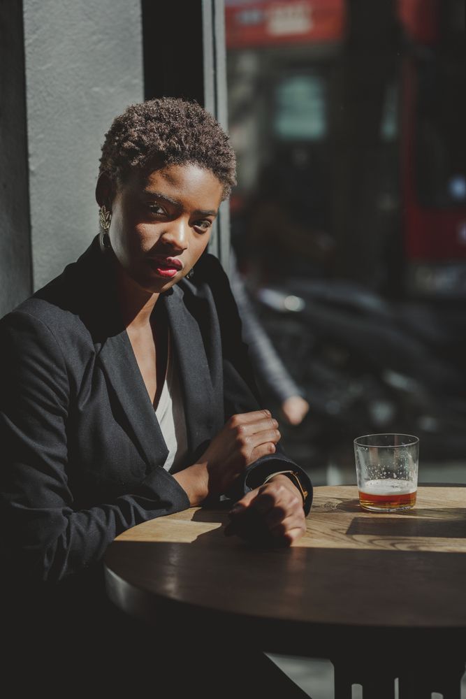 Smiling stylish Black woman in cafe
