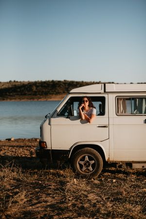 Smiling woman sitting in retro car