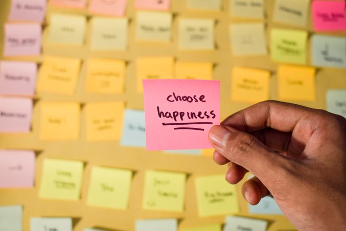 Hand hold sticky notes with words Choose Happiness