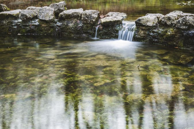 Stones between water in park