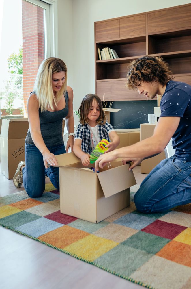 Family preparing moving toy box