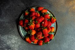 Plate of strawberries on grey counter