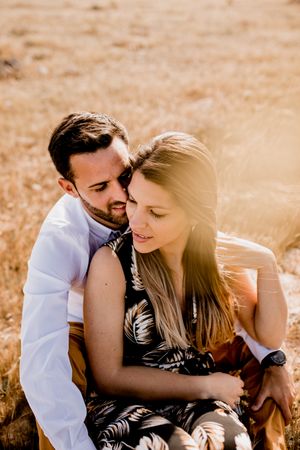 Peaceful lovers bonding on empty coastline