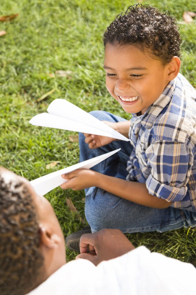 Father and Son Playing  Together with Paper Airplanes