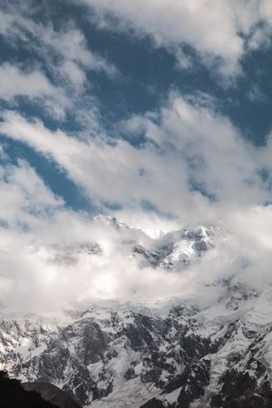 Cloudy blue sky over Fairy Meadows Nanga Parbat mountain, vertical composition