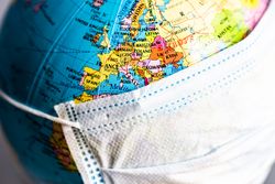 Close up of globe covered in facemask