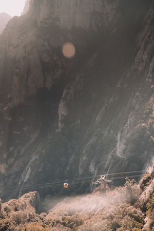 Cable car near mountains in sunny day