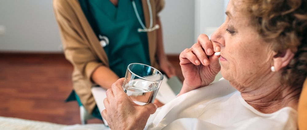 Female patient taking a pill