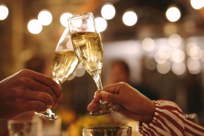 Couple toasting champagne glasses at dinner date