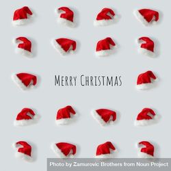Santa hats arranged on light background, with “Merry Christmas” 5w3g95