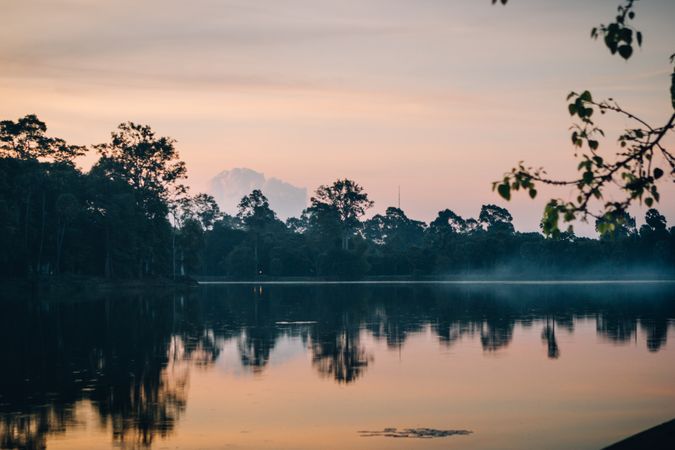 Slight fog above peaceful lake in early morning