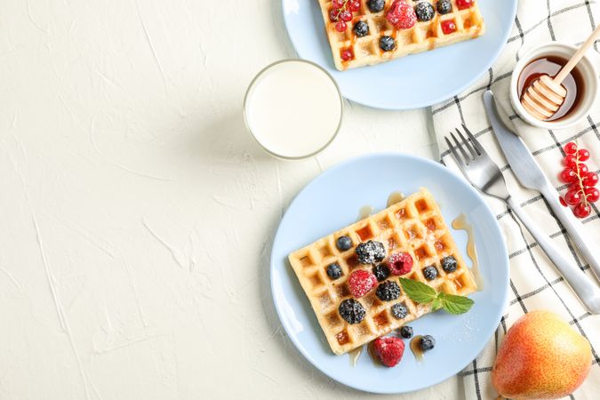 Composition of breakfast with belgian waffles, space for text