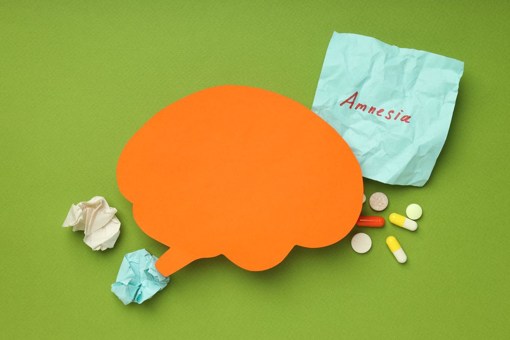 Orange paper cut out of brain on green background