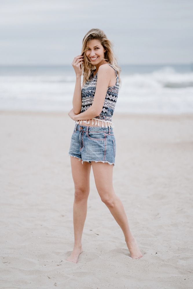 Happy female laughing on sandy beach
