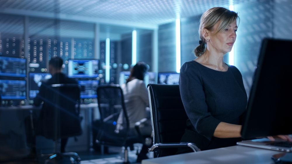 Female IT Engineer Works on Her Desktop Computer in Government Surveillance Agency.