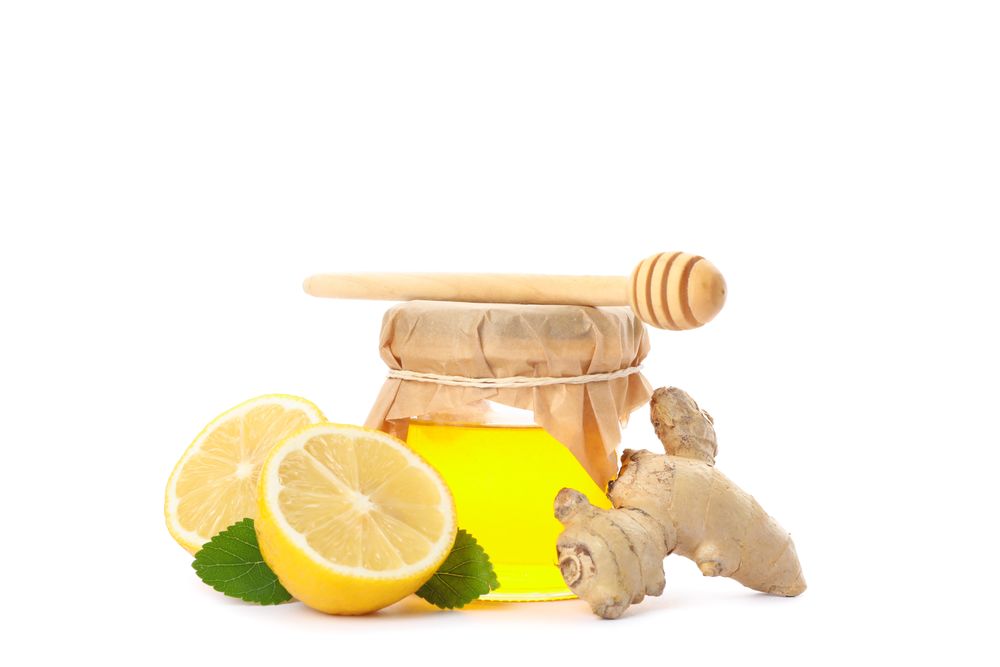 Dipper, lemons, ginger and glass jar with honey isolated on neutral background
