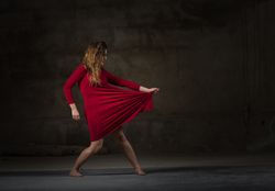Young woman dancing in darkness