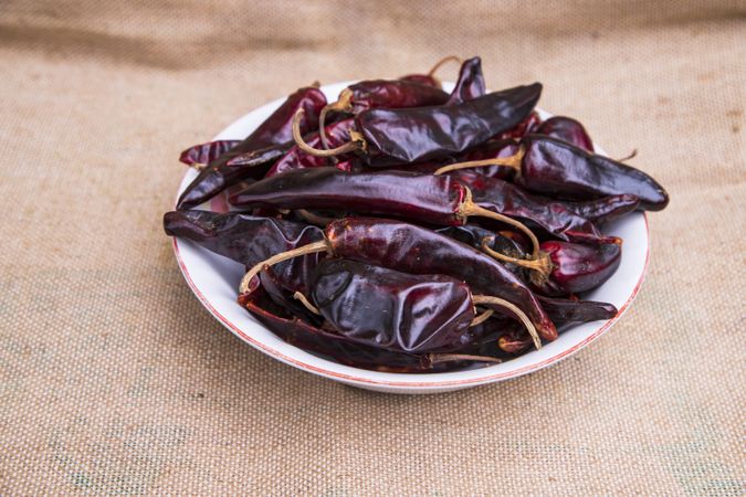 One bowl of Dry Pepper or red chili on the jute fiber fabric