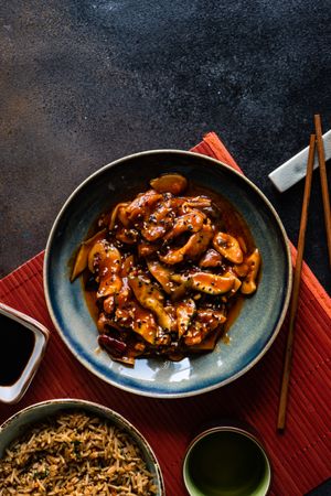 Bowl of Chinese sweet and sour pork served with chopsticks