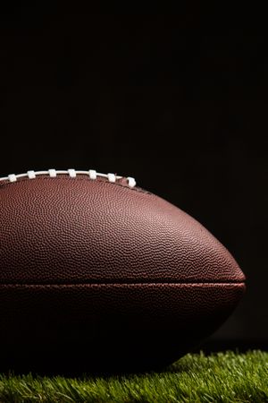 American football ball on dark background