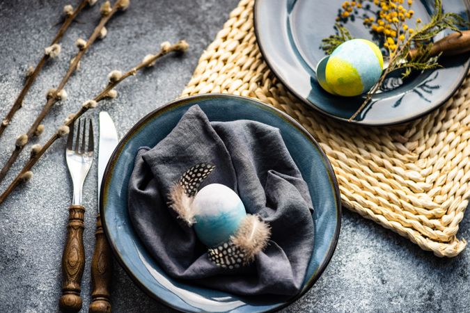 Top view of table setting with egg decorations, feathers and pussy willow
