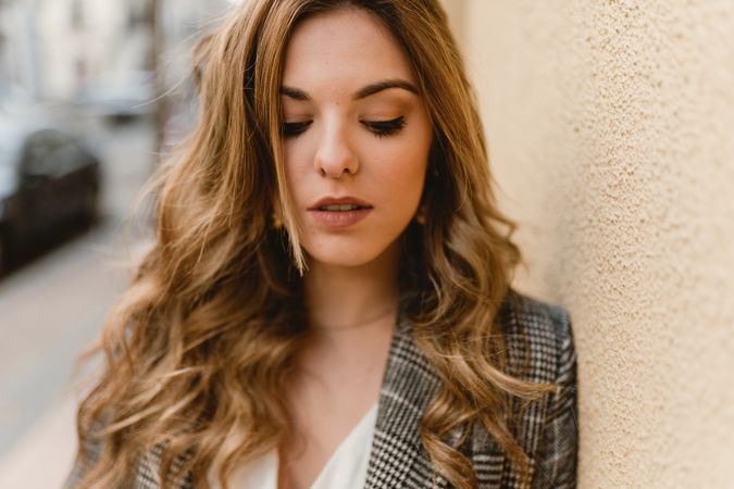 Woman leaning on wall on street