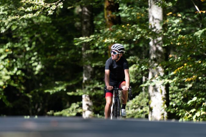 Professional cyclist riding bike in park