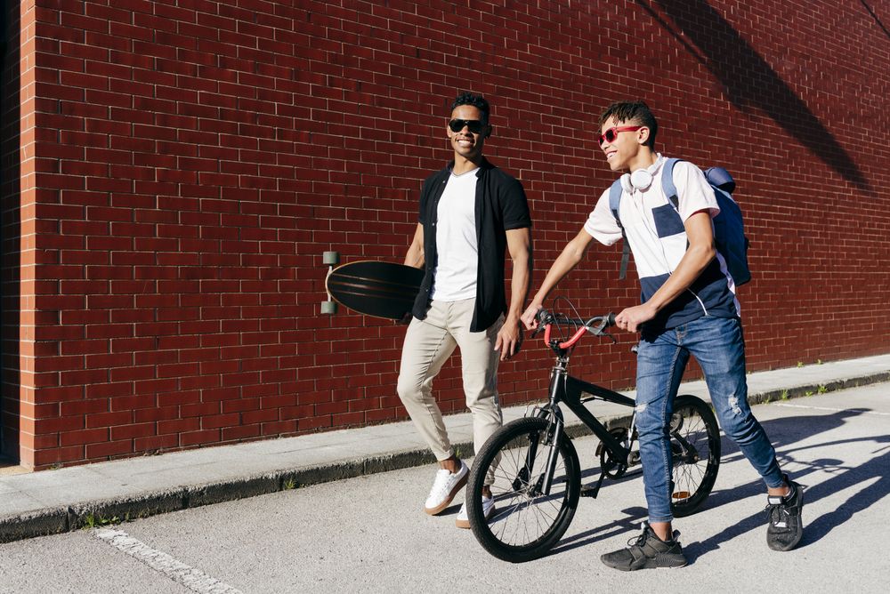 Young  cheerful men walking in city