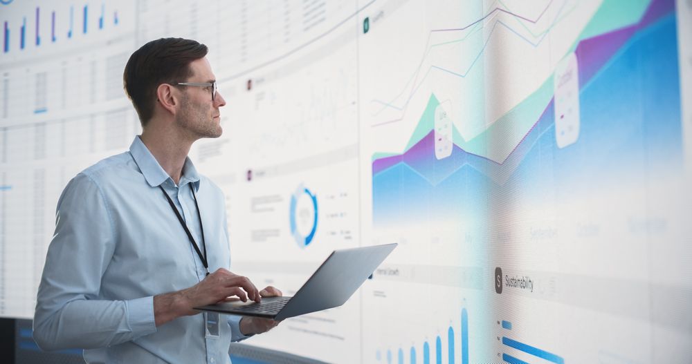 Successful Man Reviewing Financial Reports For Venture Capital Company