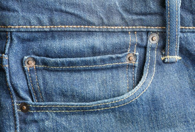 Closeup view of jeans pocket as background, space for text