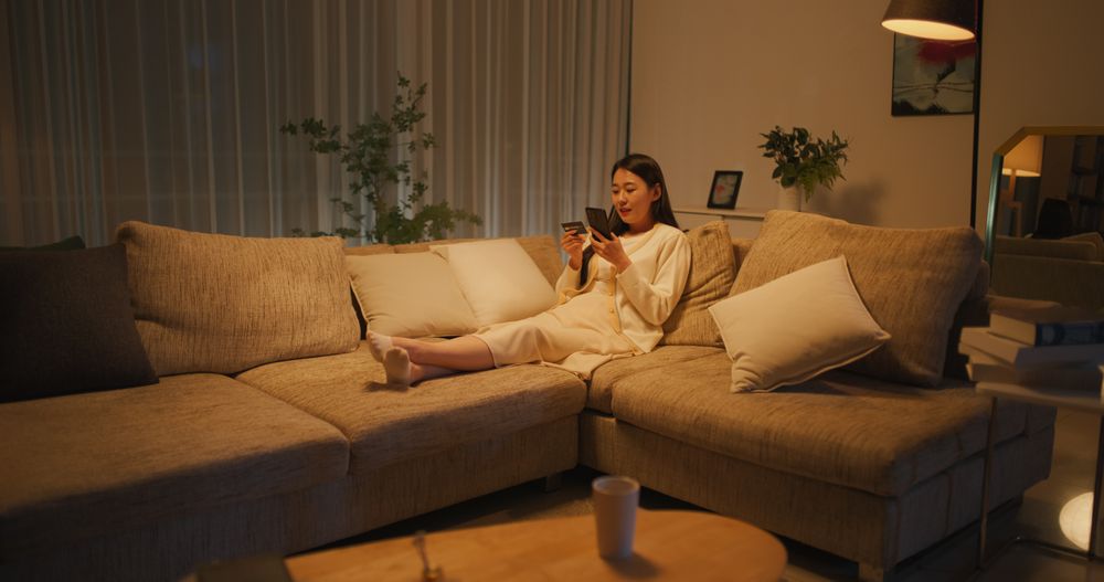 Young South Korean Woman Using Online Shopping App in a Cozy Apartment