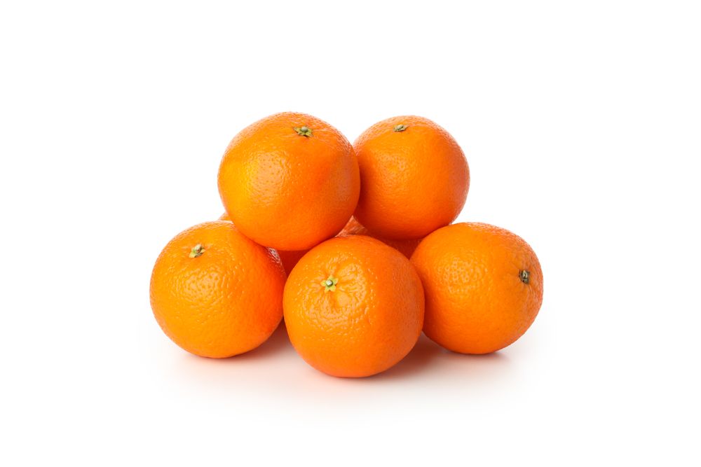 Group of ripe mandarins isolated on light background