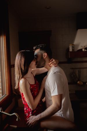 Happy couple kissing in kitchen