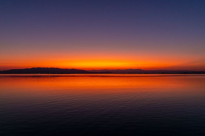 Sunset over shore and lake
