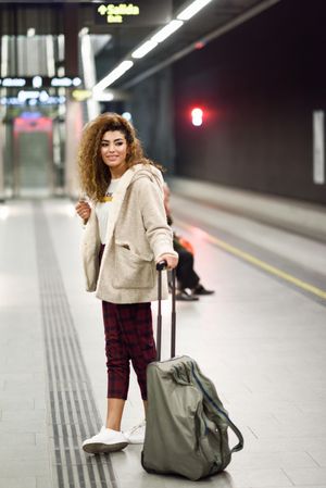 Arab woman in casual clothes with bag in subway station