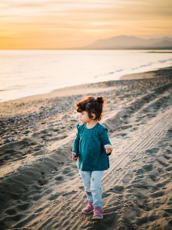 little girl looking at sea