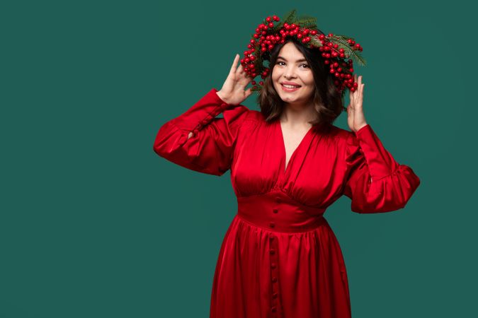 Female model in red attire with floral wreath