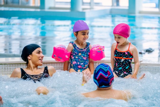 Family relaxing in bubbling pool