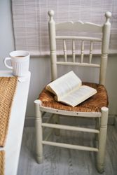 Chair with book near table with tea