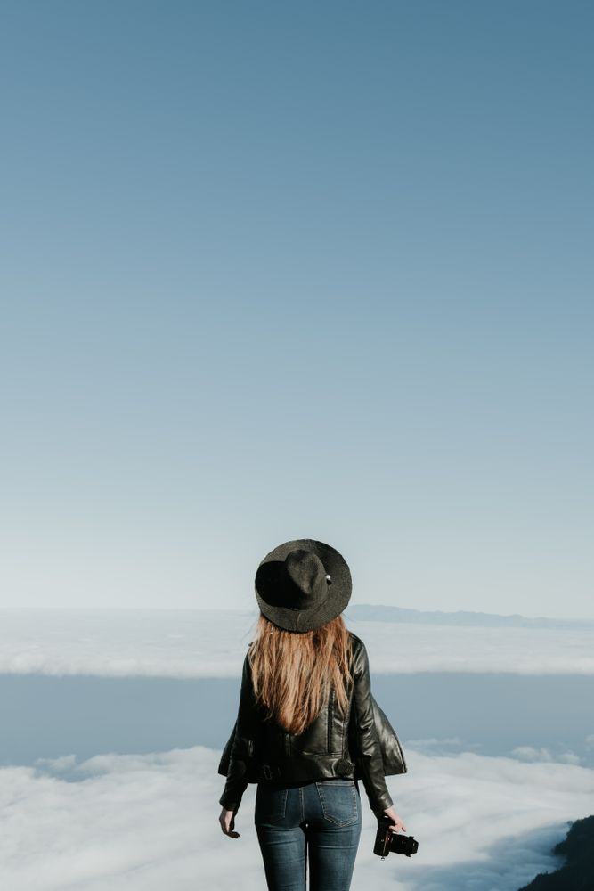 Woman with camera enjoying cloudscape