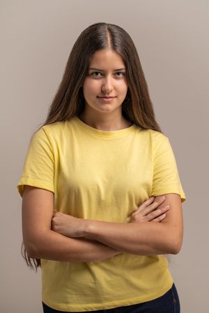 A young woman holding a reusable pink water bottle to stay hydrated.