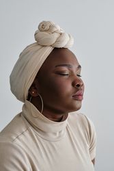 Charming Black lady in headscarf with closed eyes